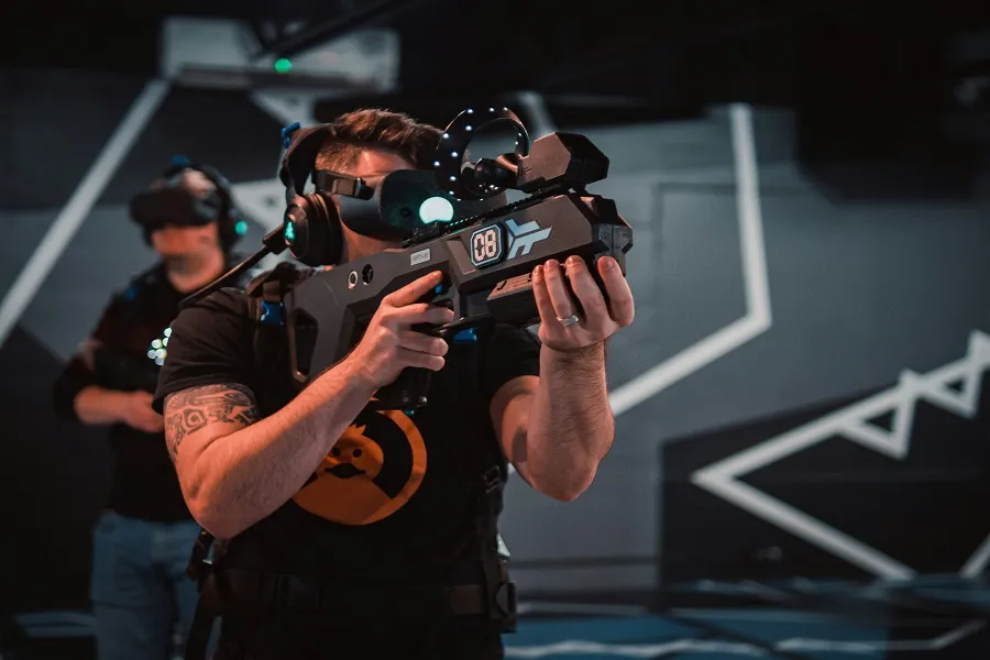 A person wearing VR headset and playing the best VR solo shooter games