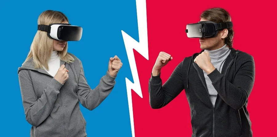 Two people wearing virtual reality headsets stand in a playful boxing stance, facing each other